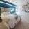 a bedroom with a bed and lamps